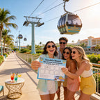 Four friends holding a Gondola Resort Bar Crawl Adventure sign with a cable car and resort in the background.