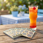 Tall glass of iced tea with a cherry on a wooden table outdoors, with 'Trek & Sip' cards nearby.
