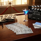 Movie-themed table setup with clapperboard, film reels, and cocktail on a wooden surface.