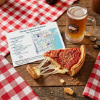 Slice of deep-dish pizza with a mug of beer and a map on a checkered tablecloth.